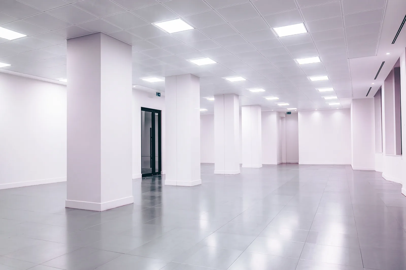 Bright all-white open office with glossy floors