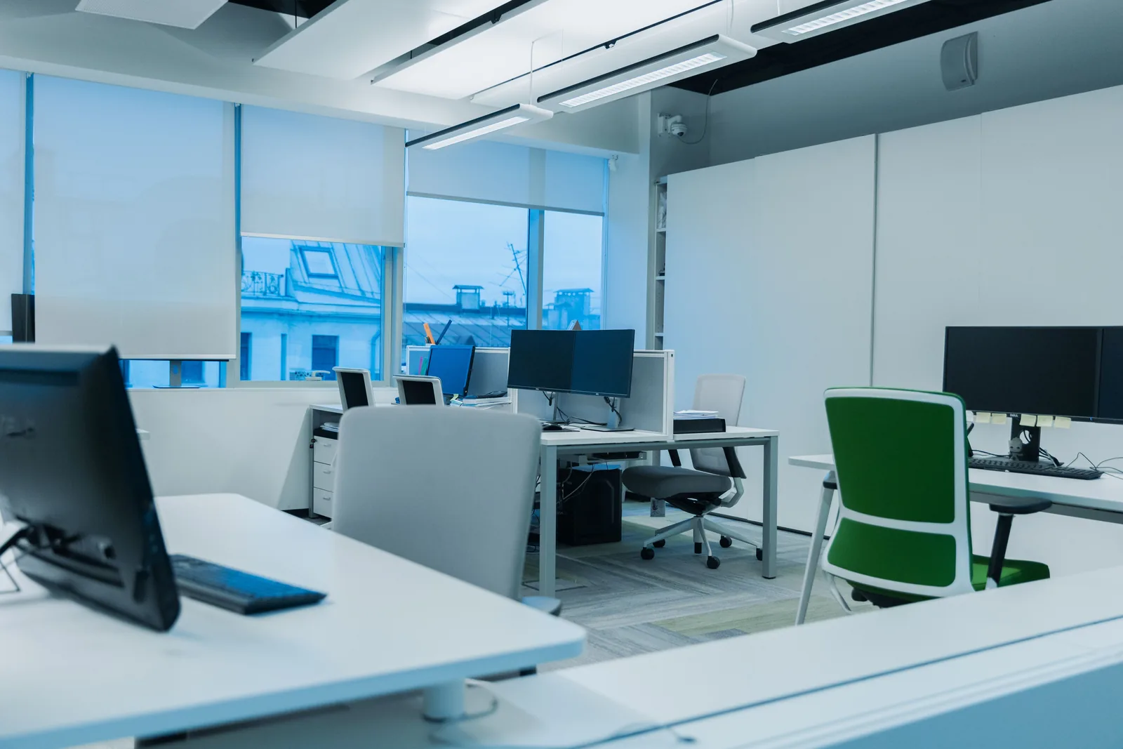 Bright office with neat desks and monitors