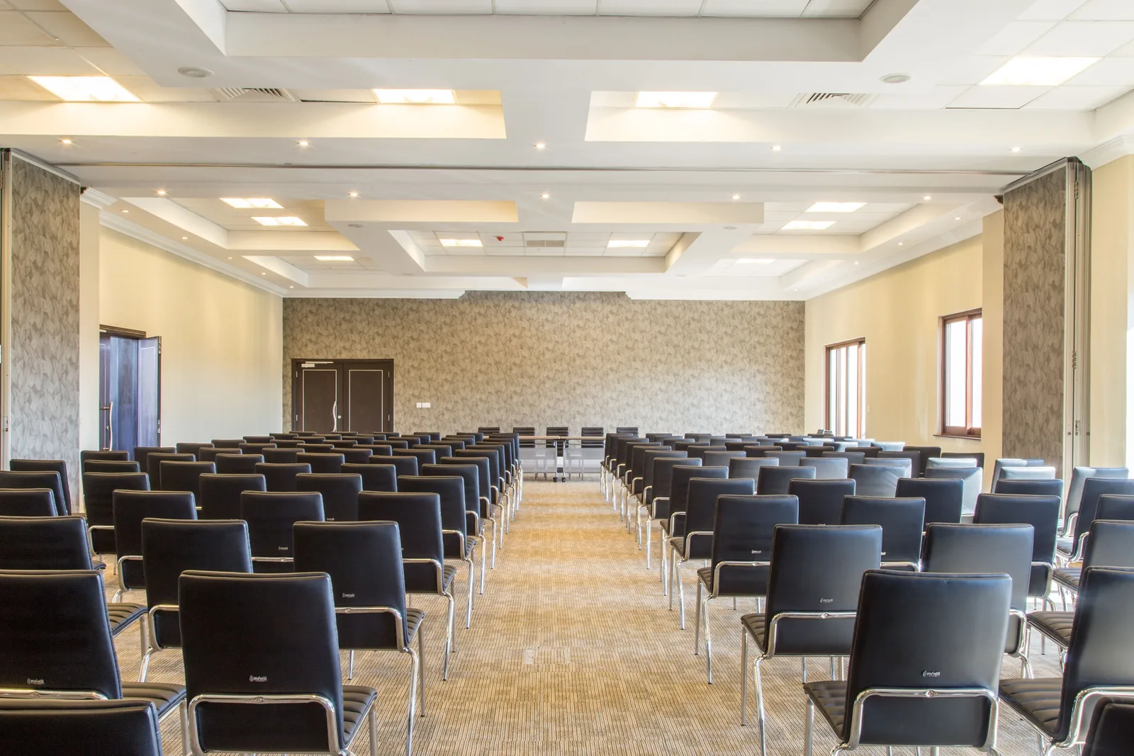 Large event hall set with rows of chairs